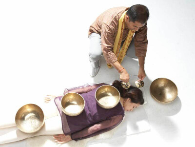 Suren Shrestha administering a singing bowl healing session.